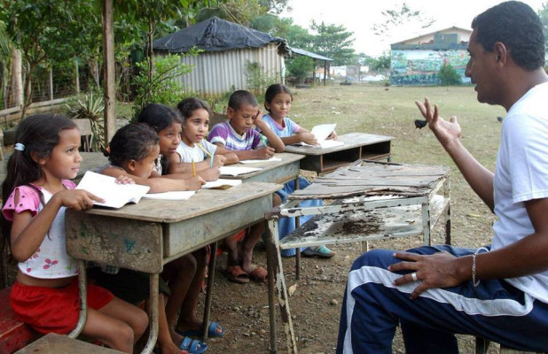 Children at desks outside.