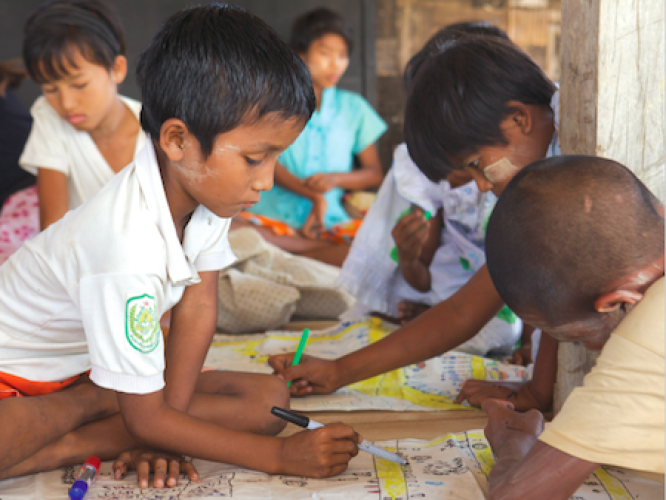 Children working together to make posters