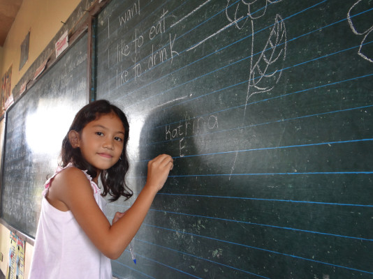 Girl at a blackboard in the Philippines.